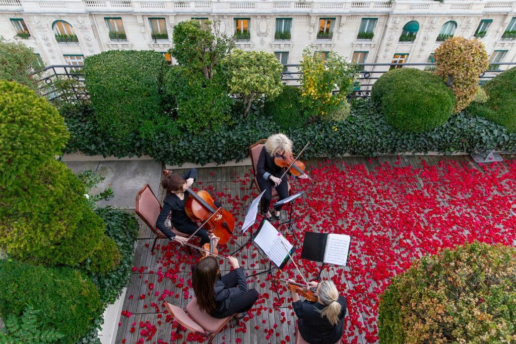 dream marriage proposal on the rooftop of the Raphael Hotel Paris with thousands of rose petals and musicians