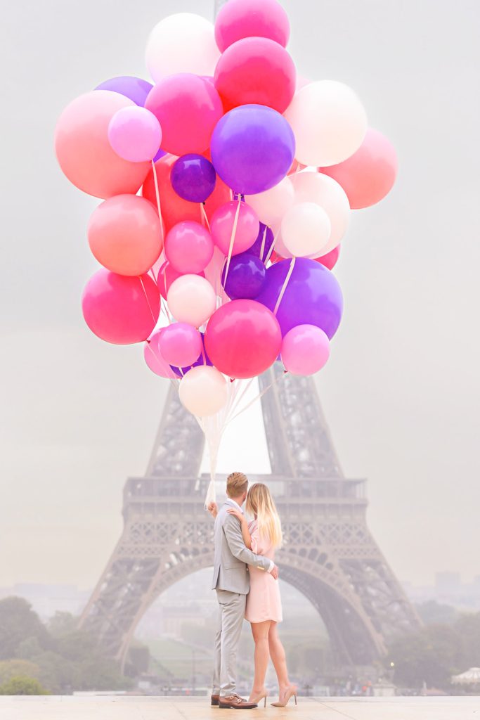Eye catching massive bouquet of colorful balloons as props for a couple photoshoot at the Eiffel Tower.