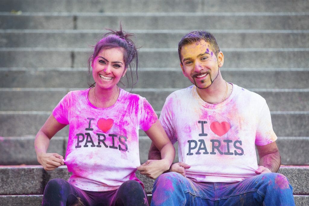 Indian couple photography ideas using colorful props to personalize the photo outfits in Paris