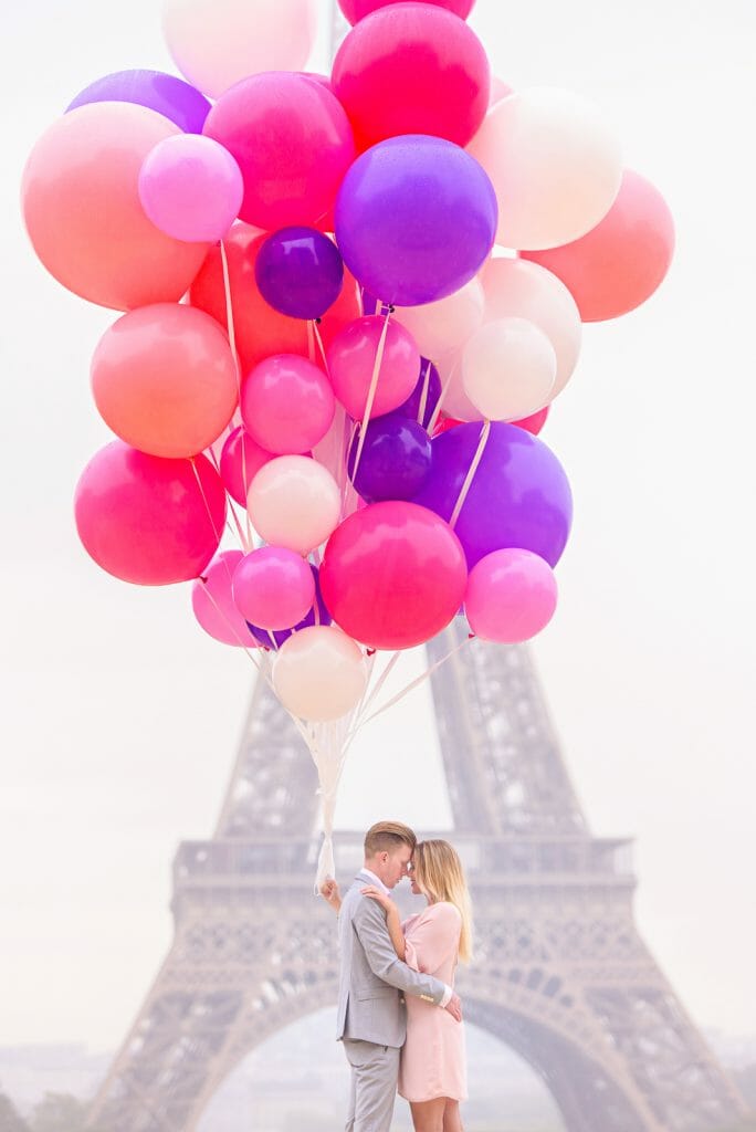 Creative couple photoshoot ideas in Paris with massive balloons in front of the Eiffel Tower