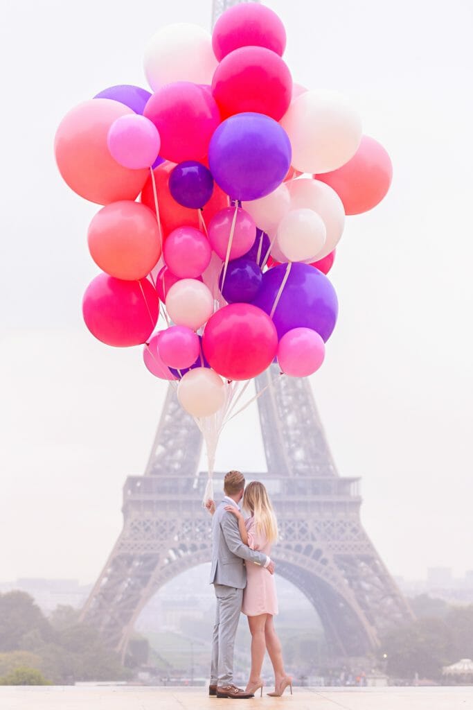 Creative couple photoshoot ideas in Paris with massive balloons in front of Eiffel Tower