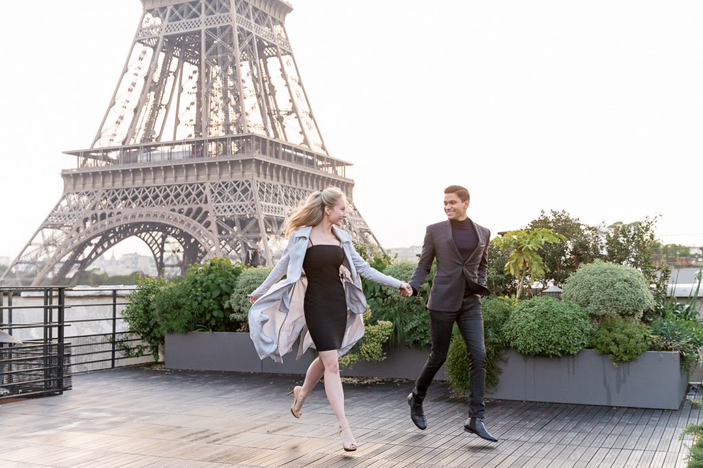 Unusual Eiffel Tower engagement photos taken on a private rooftop of happy couple