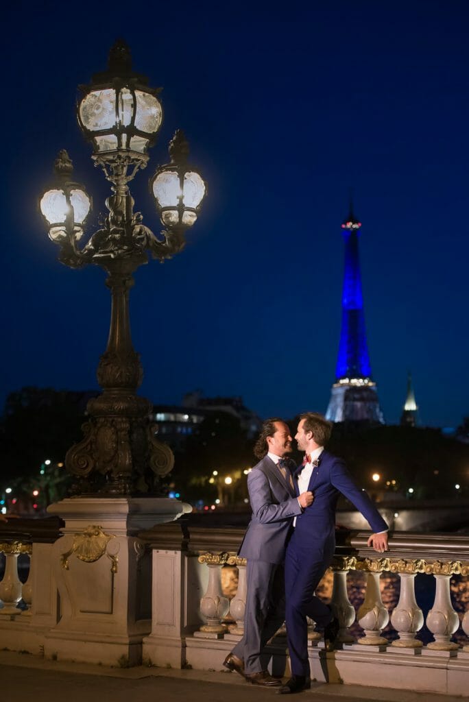 Romantic gay couple photoshoot at night on Alexander III Bridge