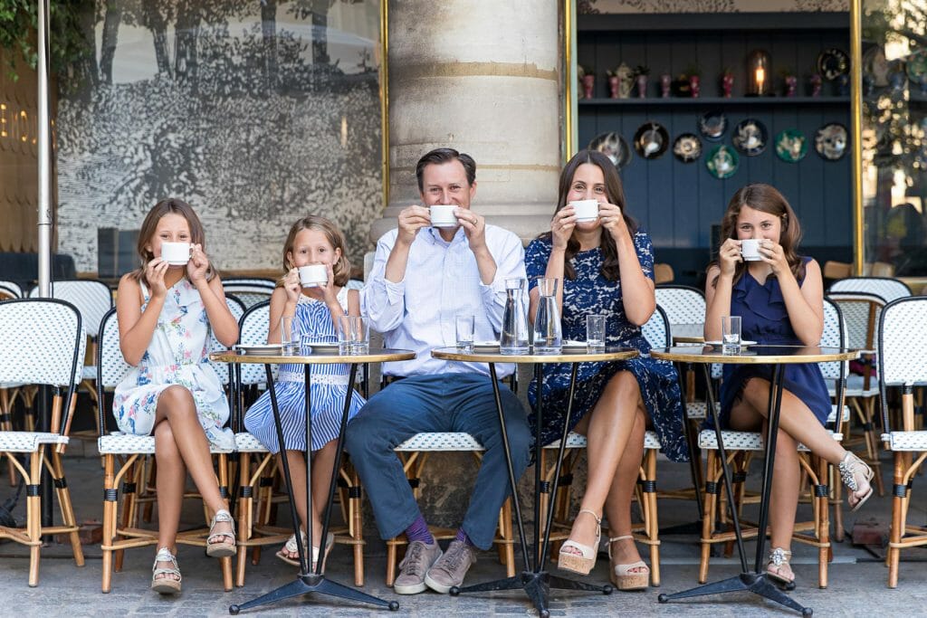 Professional Paris family photos with cafe as prop