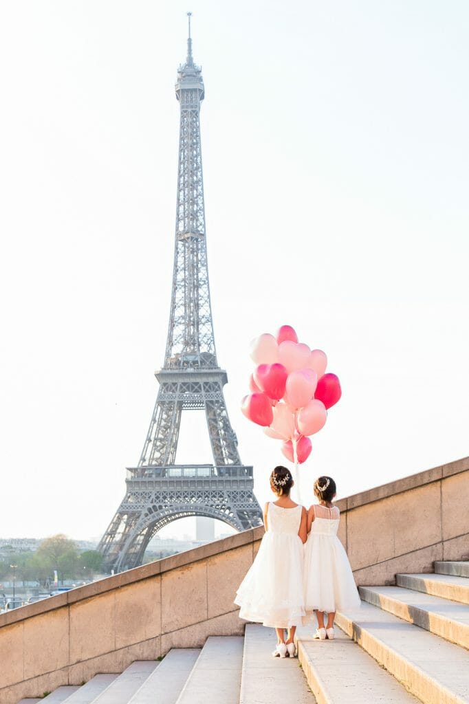 Adorable Paris kids and family photos at the Eiffel Tower with pink balloons