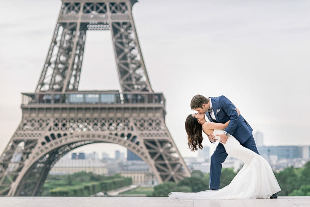 paris pre wedding photographer couple poses at the Eiffel Tower at sunrise