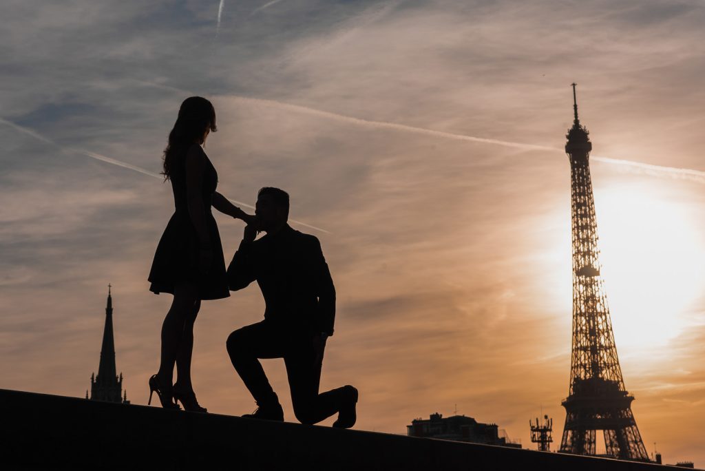 Paris couple photoshoot at night with Eiffel Tower as silhouette