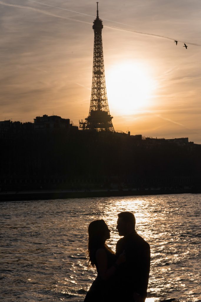Paris couple photoshoot at night with Eiffel Tower as silhouette