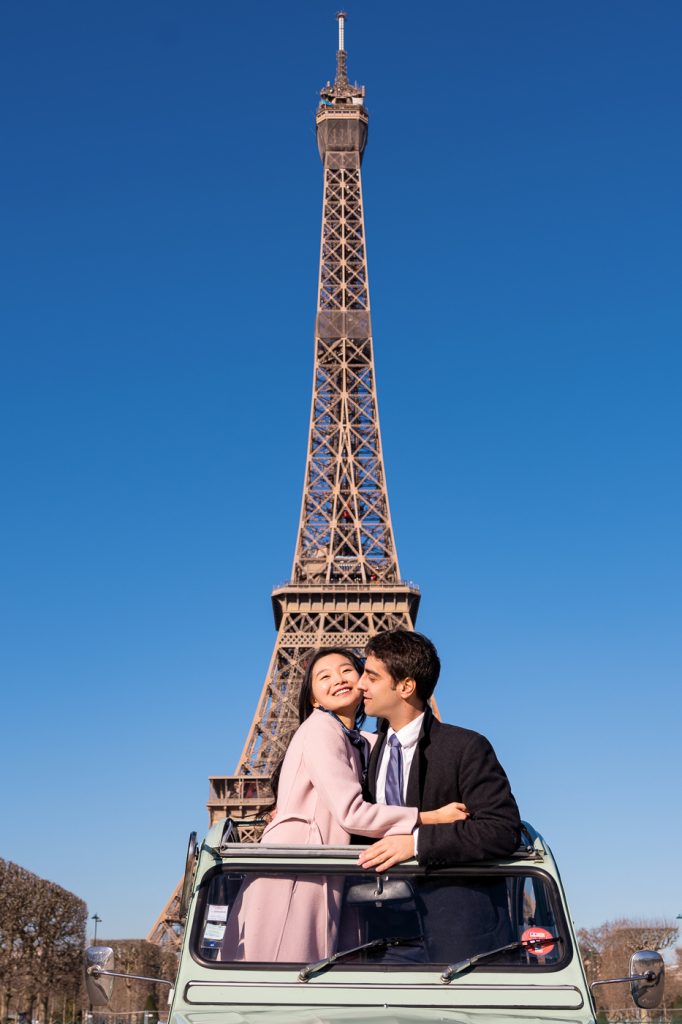 cute engagement photos at the Eiffel Tower in a classic French vintage car