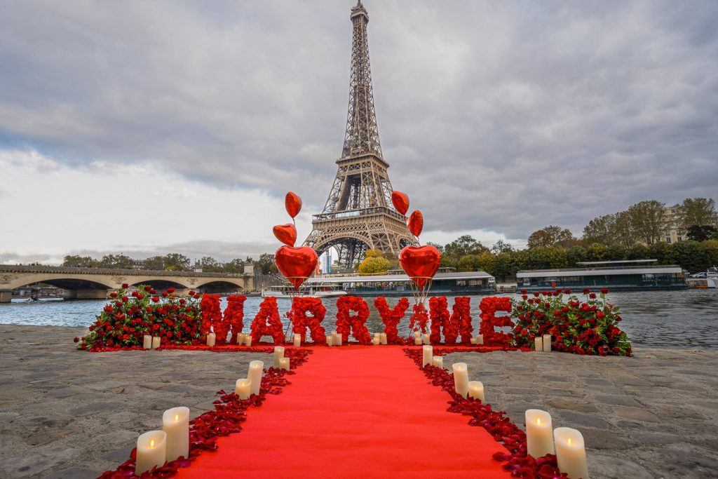 Famous Eiffel Tower marriage proposal with Marry Me sign and red roses