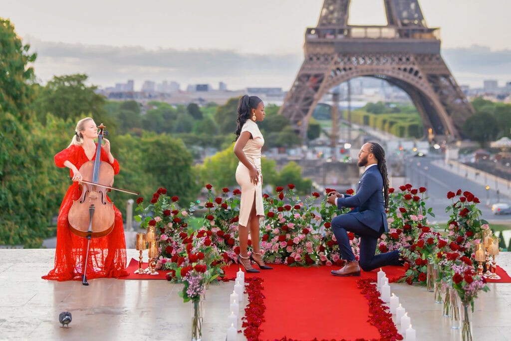 Public Eiffel Tower proposal at Trocadero with stunning floral design and musician
