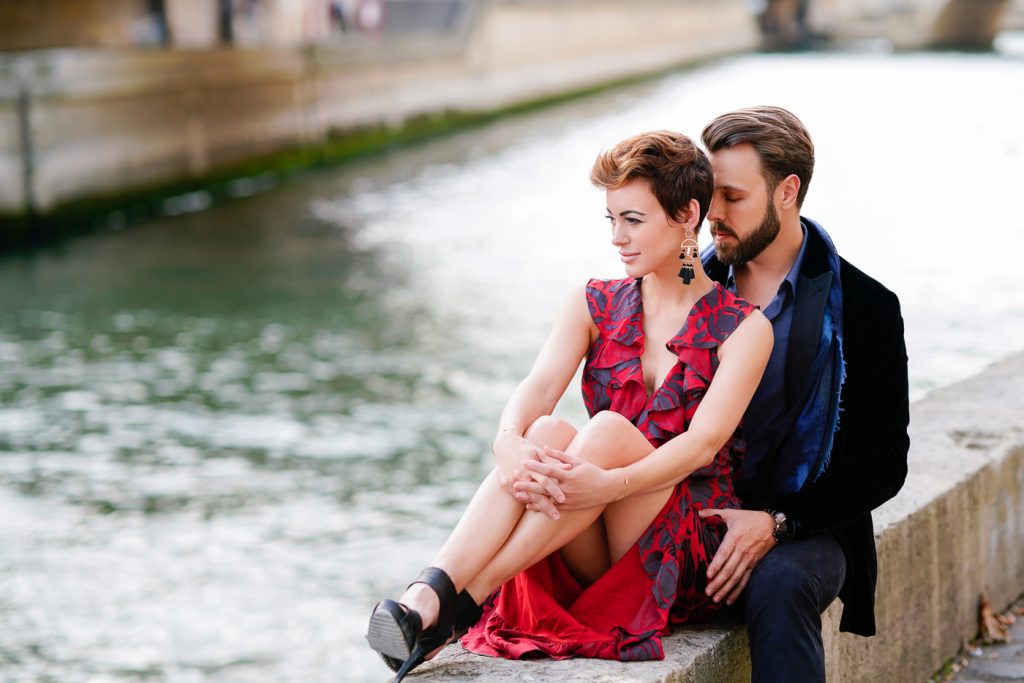 Romantic photo of couple connecting down by the Seine near Notre Dame