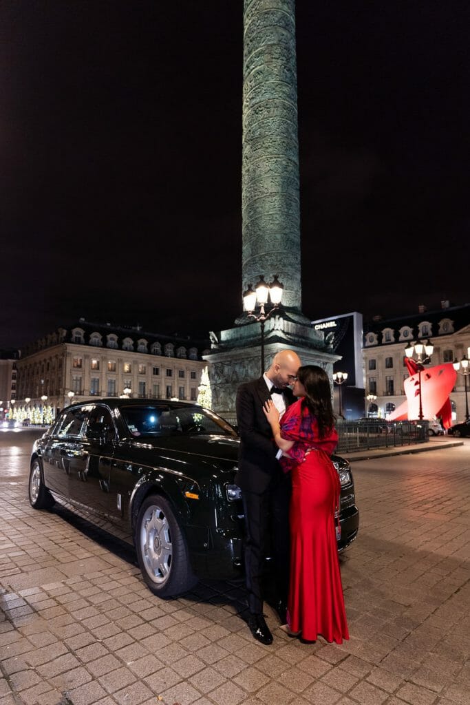 Incredible engagement photos at Place Vendôme with couple kissing in front of a Rolls-Royce