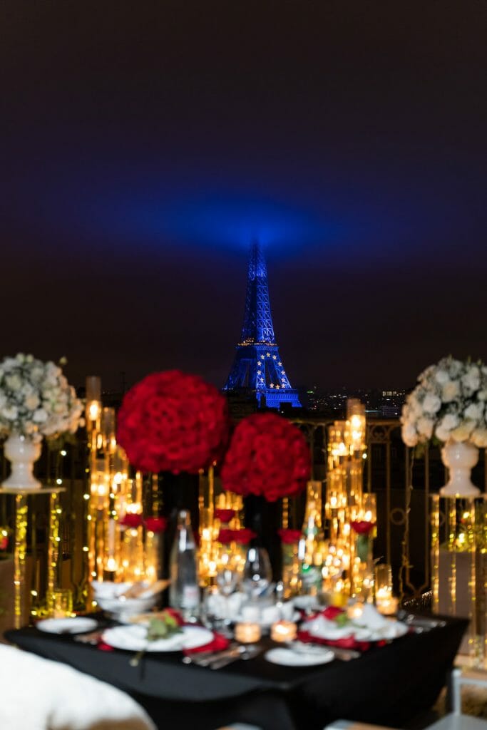 Winter-white Peninsula Hotel Paris Proposal ideas with Eiffel Tower lit up in Blue