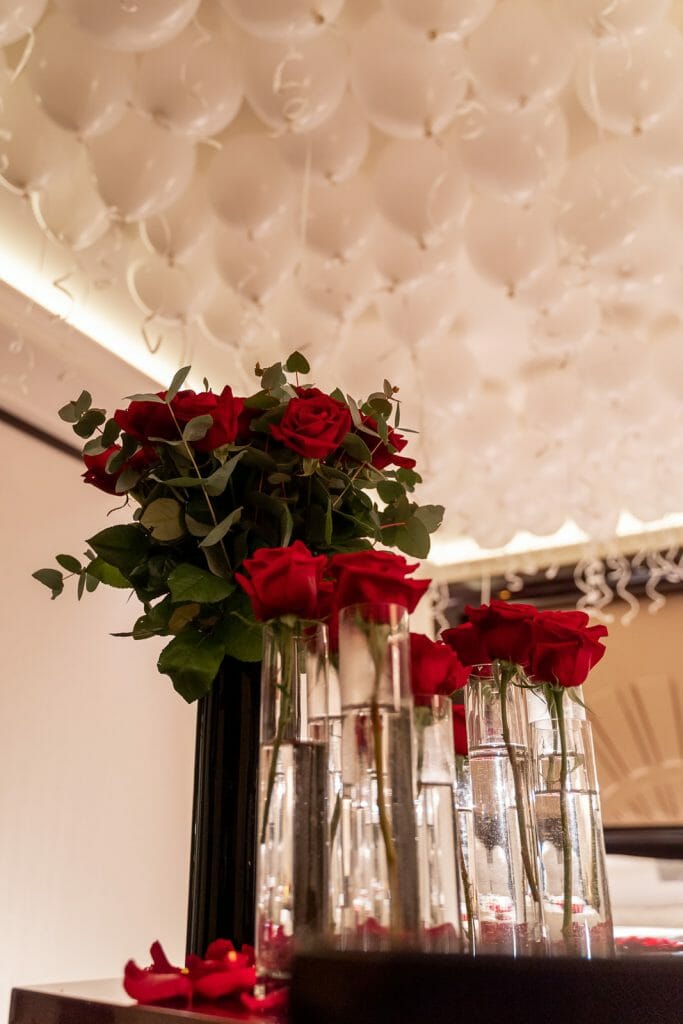 Peninsula Hotel Paris Proposal surprise hotel suite embellishment with red roses and white balloons
