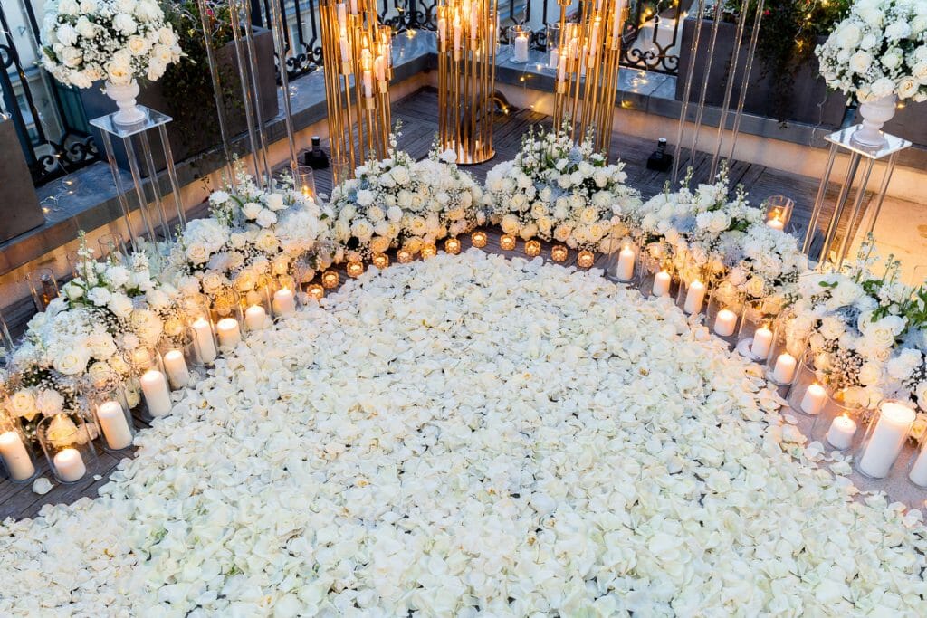 Winter marriage proposal at the Peninsula Hotel Paris with candles and white rose petals