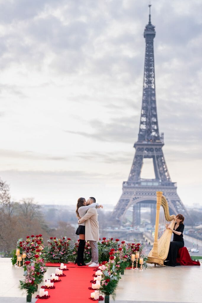 Luxury Eiffel Tower marriage proposal at Trocadero at sunrise with harpist musician and stunning floral design