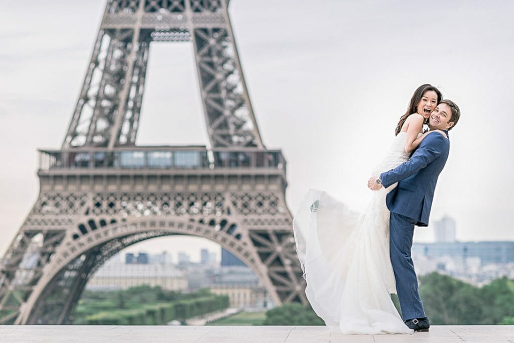pre wedding photoshoot Eiffel tower cute couple photo of groom lifting bride