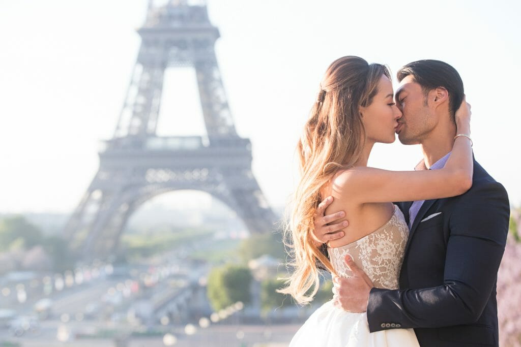 passionate kiss during a pre-wedding photoshoot with Eiffel tower view
