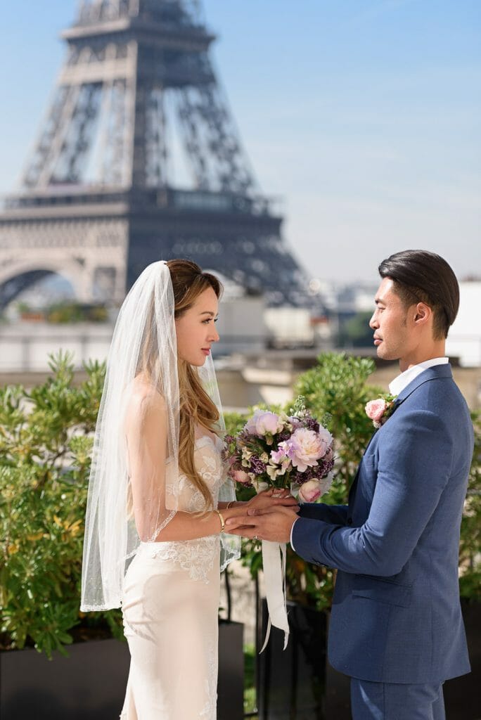 Groom holding bride hands at Shangri la Paris