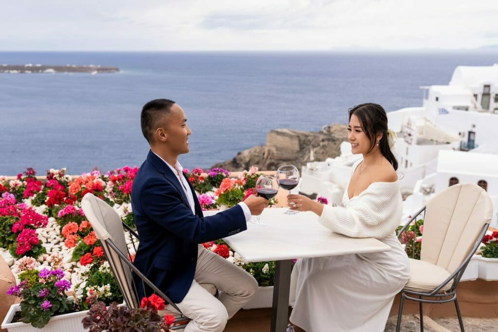 Couple photos in Santorini drinking wine