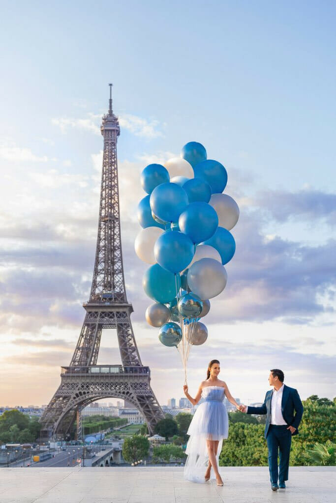 Couple poses with balloons: couple walking toward the camera.