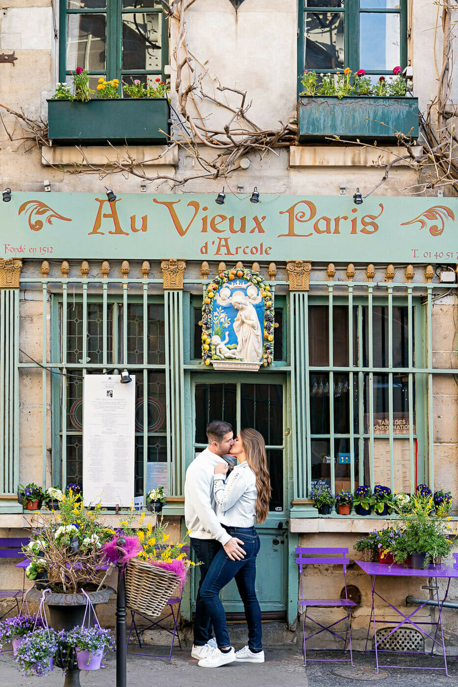 Cute couple photoshoot at the oldest Cafe in Paris near Notre Dame Cathedral