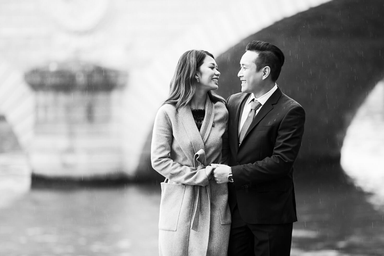 Romantic couple photos near Notre Dame Cathedral with Paris in the rain