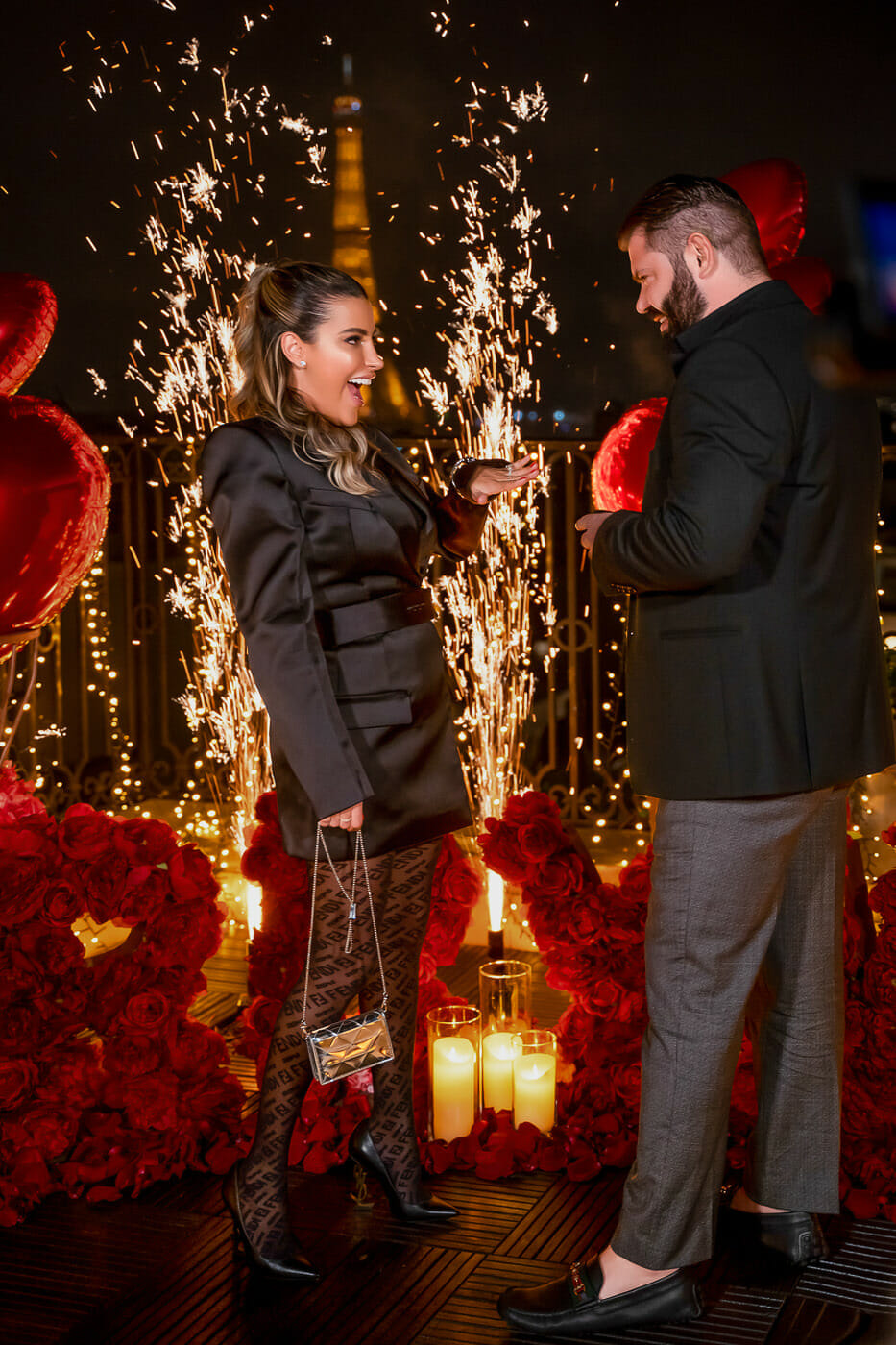 Luxury marriage proposal at the Peninsula Hotel Paris with Marry Me sign made out of roses