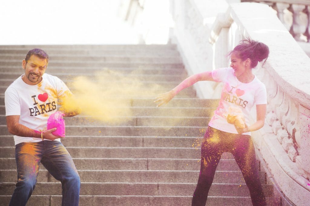 Indian couple photoshoot using colorful props in Paris at the Alexander III Bridge