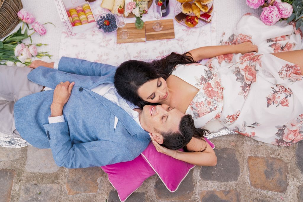Couple photoshoot in Paris with fabulous picnic as prop at the Seine River with Eiffel Tower as backdrop