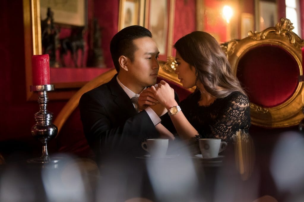 Cafe as prop for dreamy couple photo at Au Vieux Paris d’Arcole Cafe with Notre
