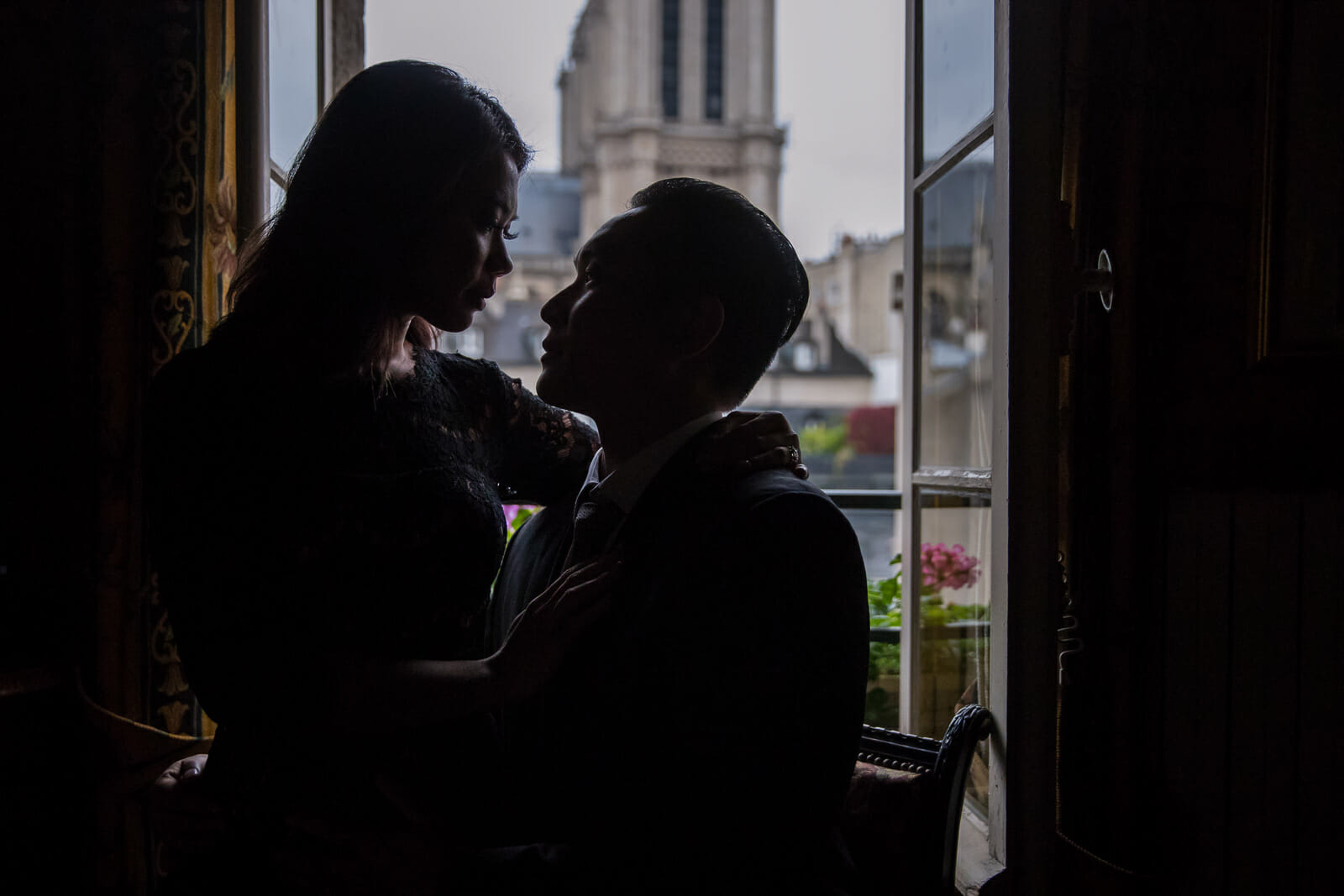 Dreamy couple photos at Au Vieux Paris d'Arcole Cafe with Notre Dame view