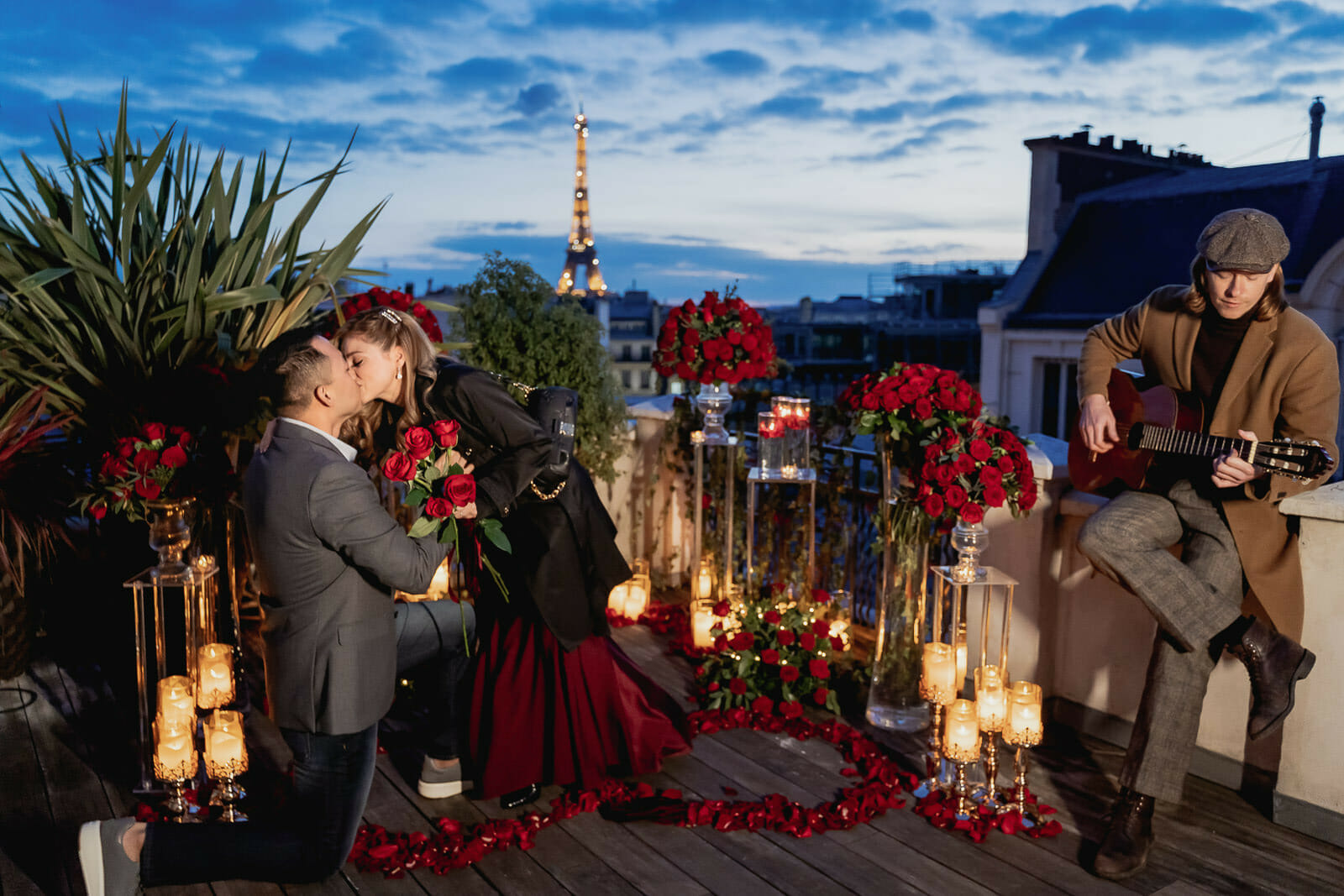 Luxury Paris rooftop proposal with guitarist and lots of red rose petals