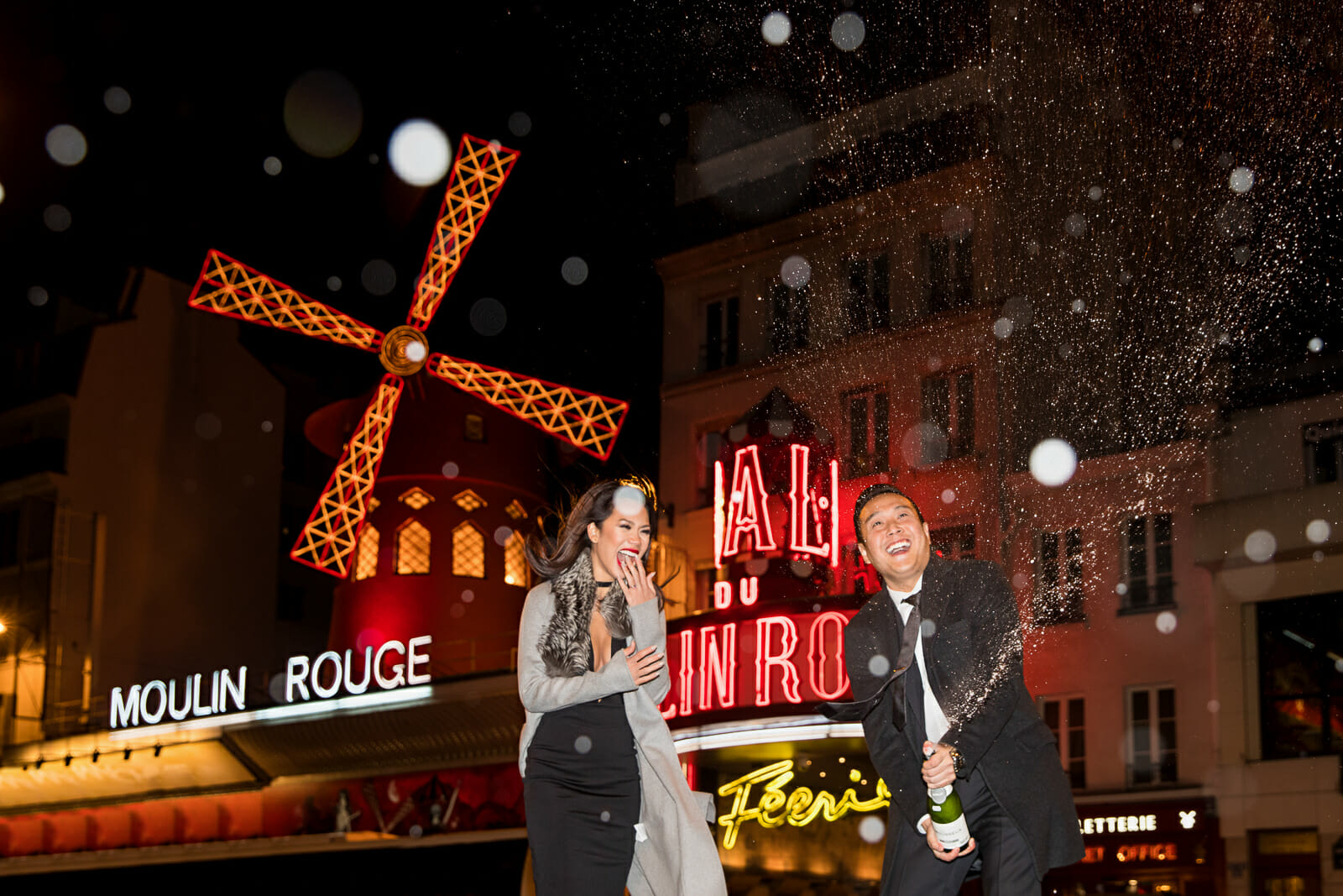 Paris couple photography with Champagne pop at Moulin Rouge