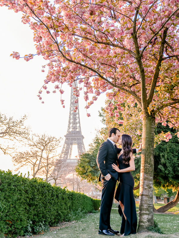 Paris engagement photos at the Eiffel Tower with Cherry Blossoms in bloom