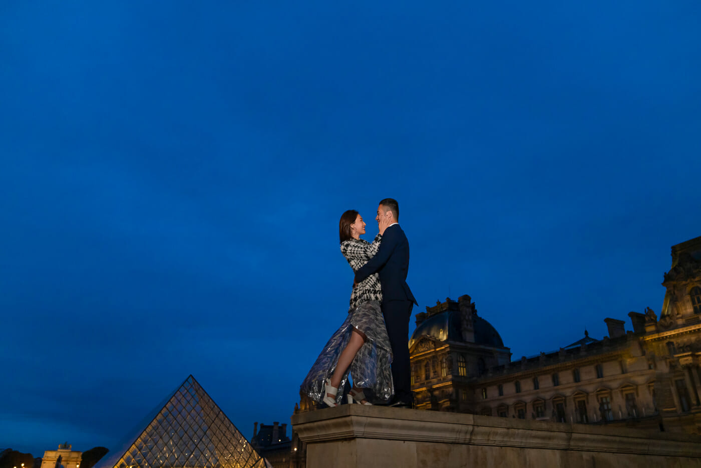 Couple engagement photos at the Louvre during the magical Blue Hour