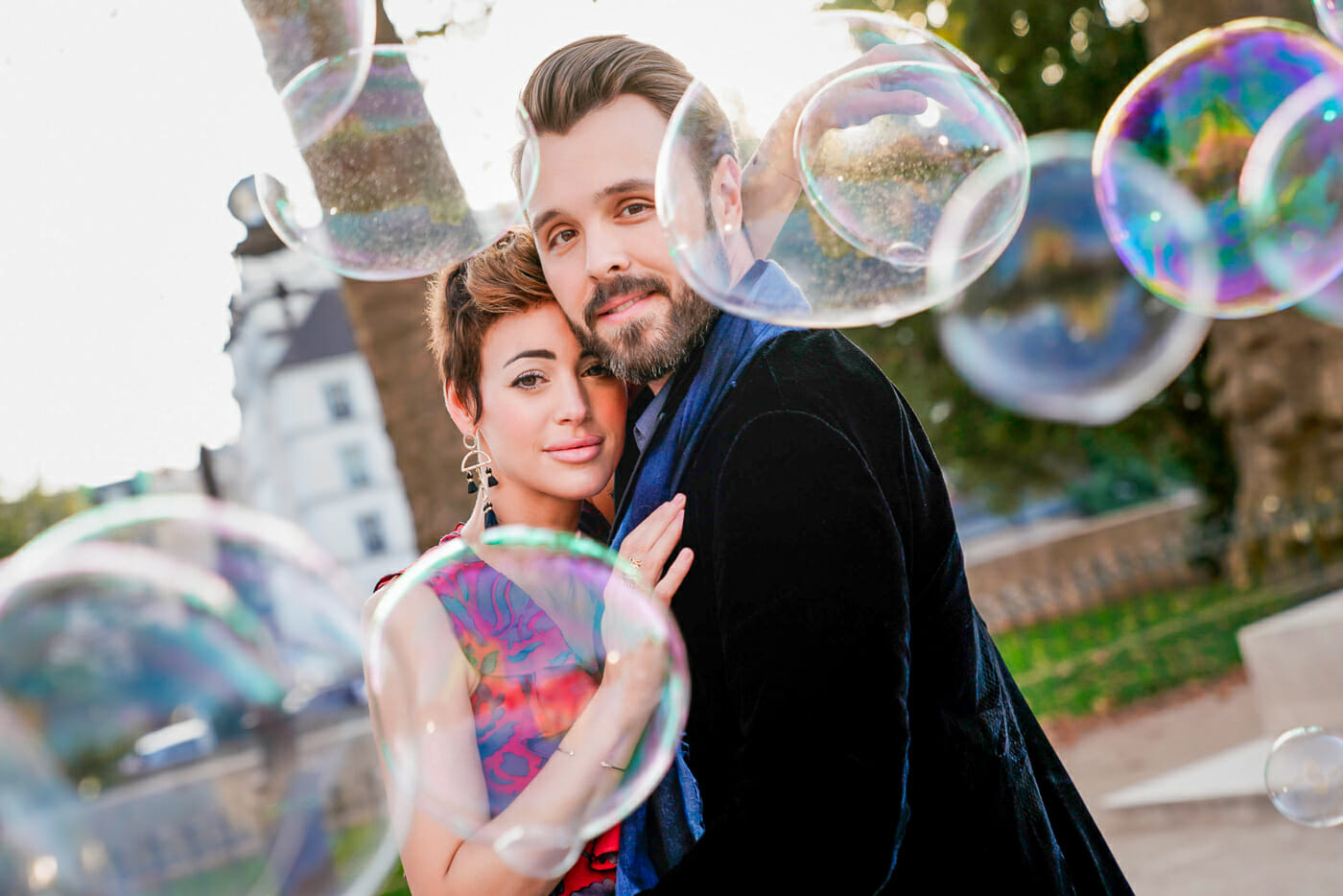 Creative Paris engagement photo with massive bubbles used as a prop