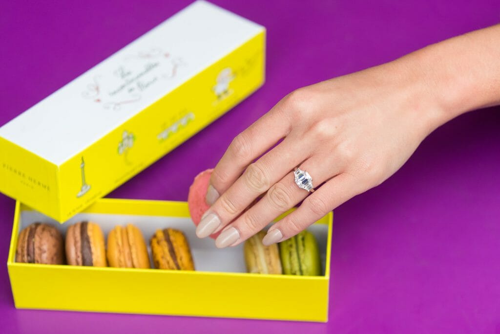 pierre hermé macaron as props for engagement photos in Paris