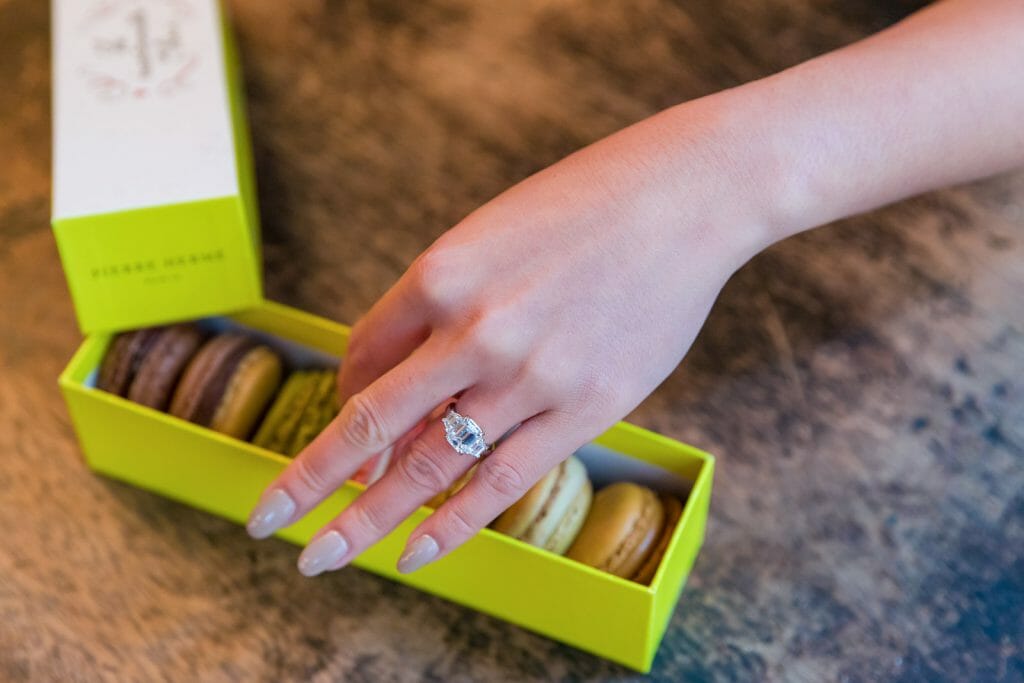 pierre hermé macaron as props for engagement photos in Paris
