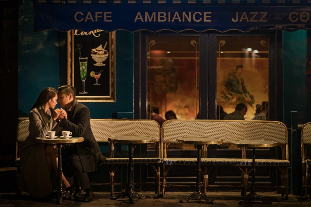 Prettiest cafes in Paris romantic nighttime couple photoshoot at Montmartre