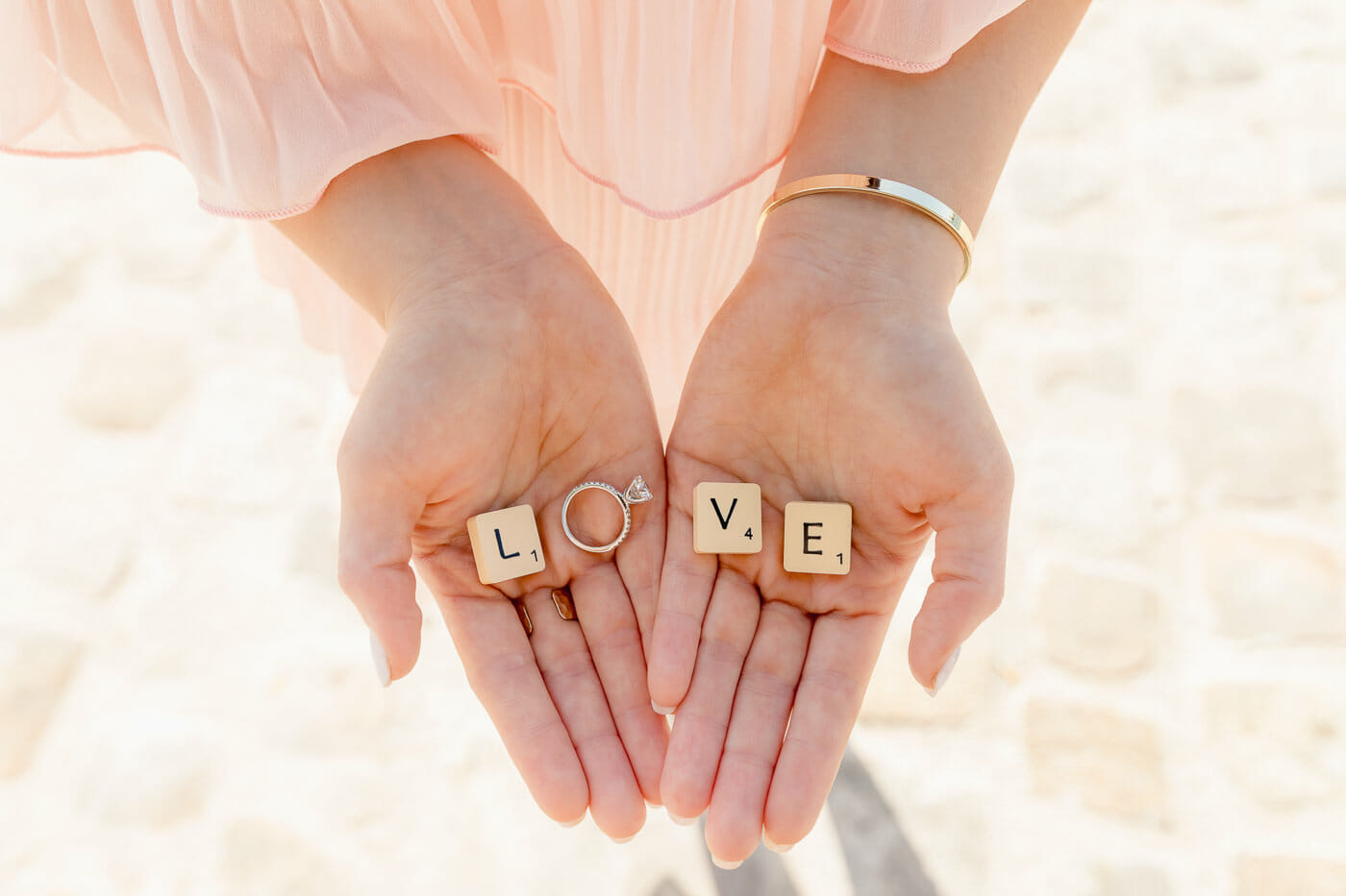 Creative engagement photos that show the diamond ring with LOVE