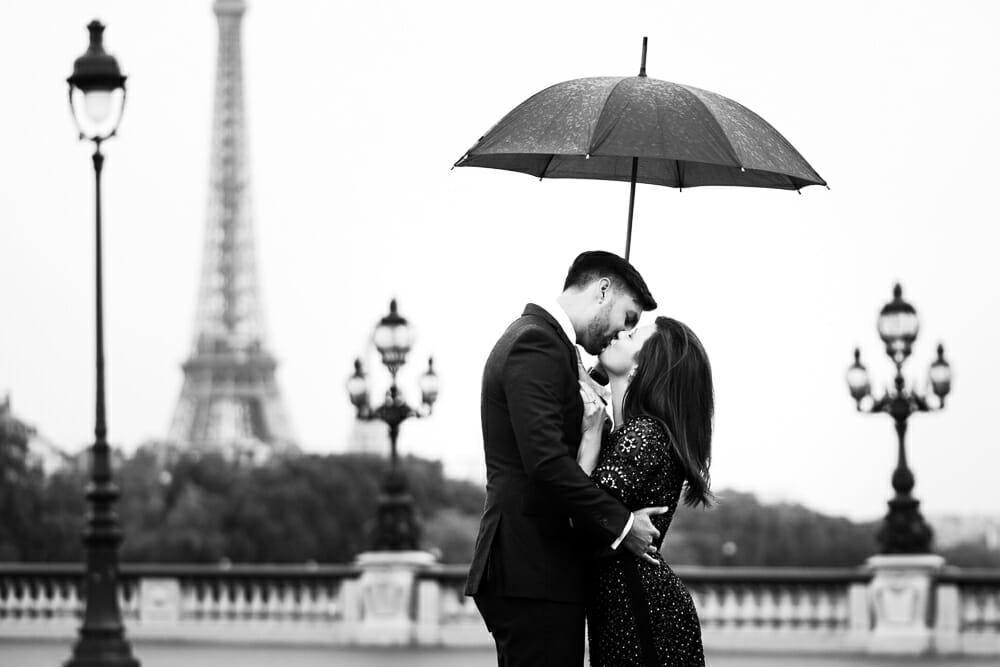 Romantic Eiffel Tower couple pictures in the rain on Alexander III Bridge