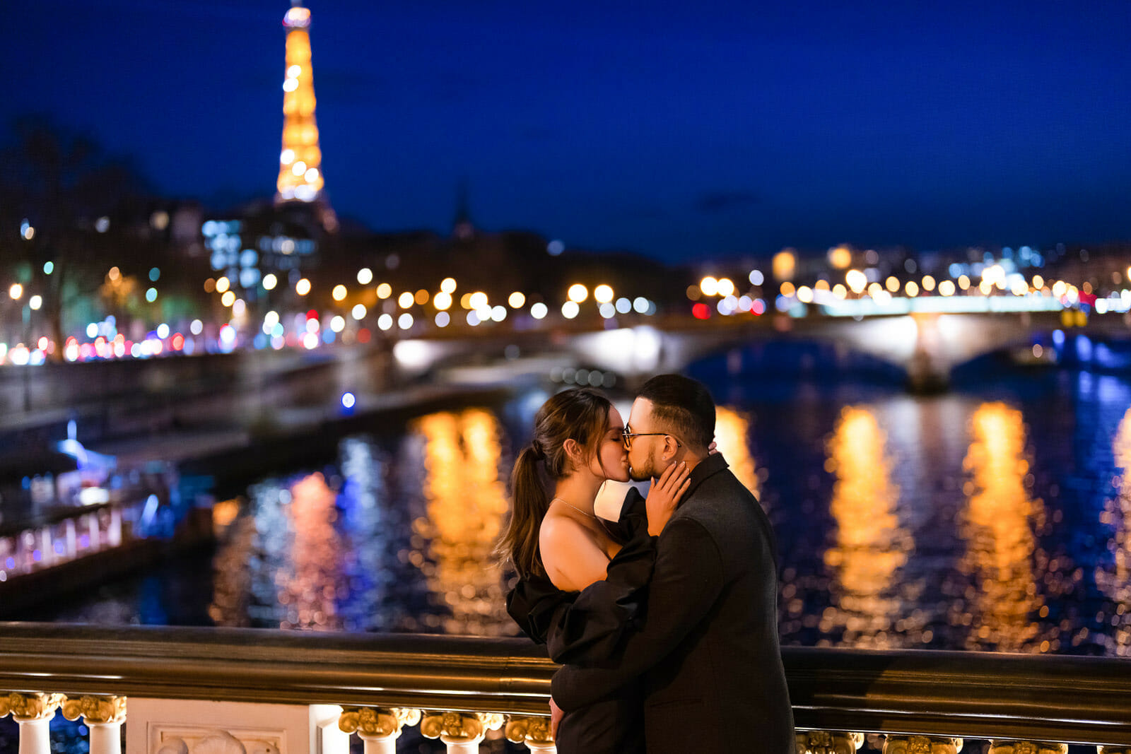 Romantic Paris couple photoshoot at Alexander III Bridge during the Blue Hour with Eiffel Tower sparkling