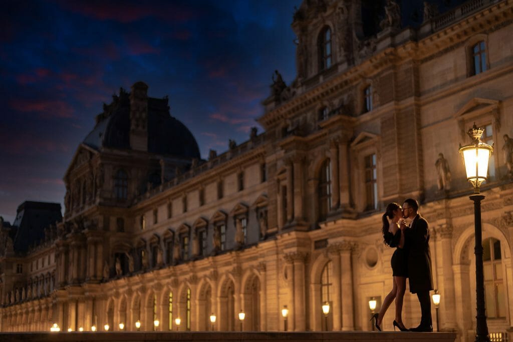 Super Romantic Paris engagement photos at the Louvre Museum during the Blue Hour