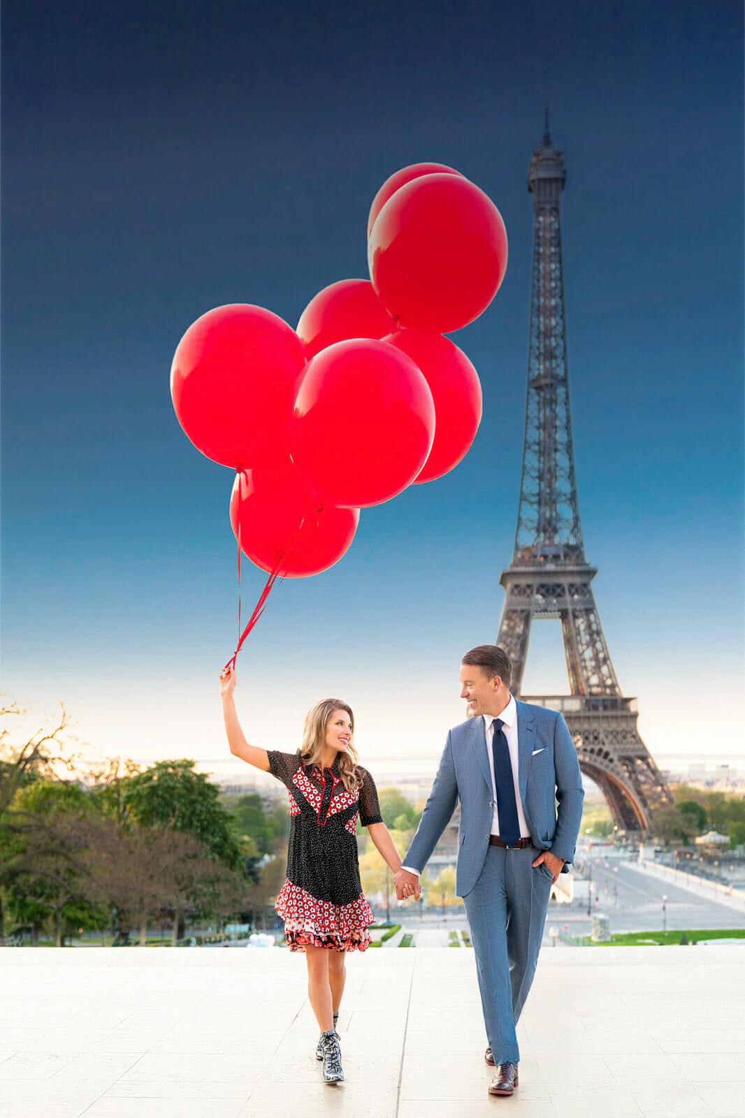 Paris engagement photos with stunning red balloons at the Eiffel Tower