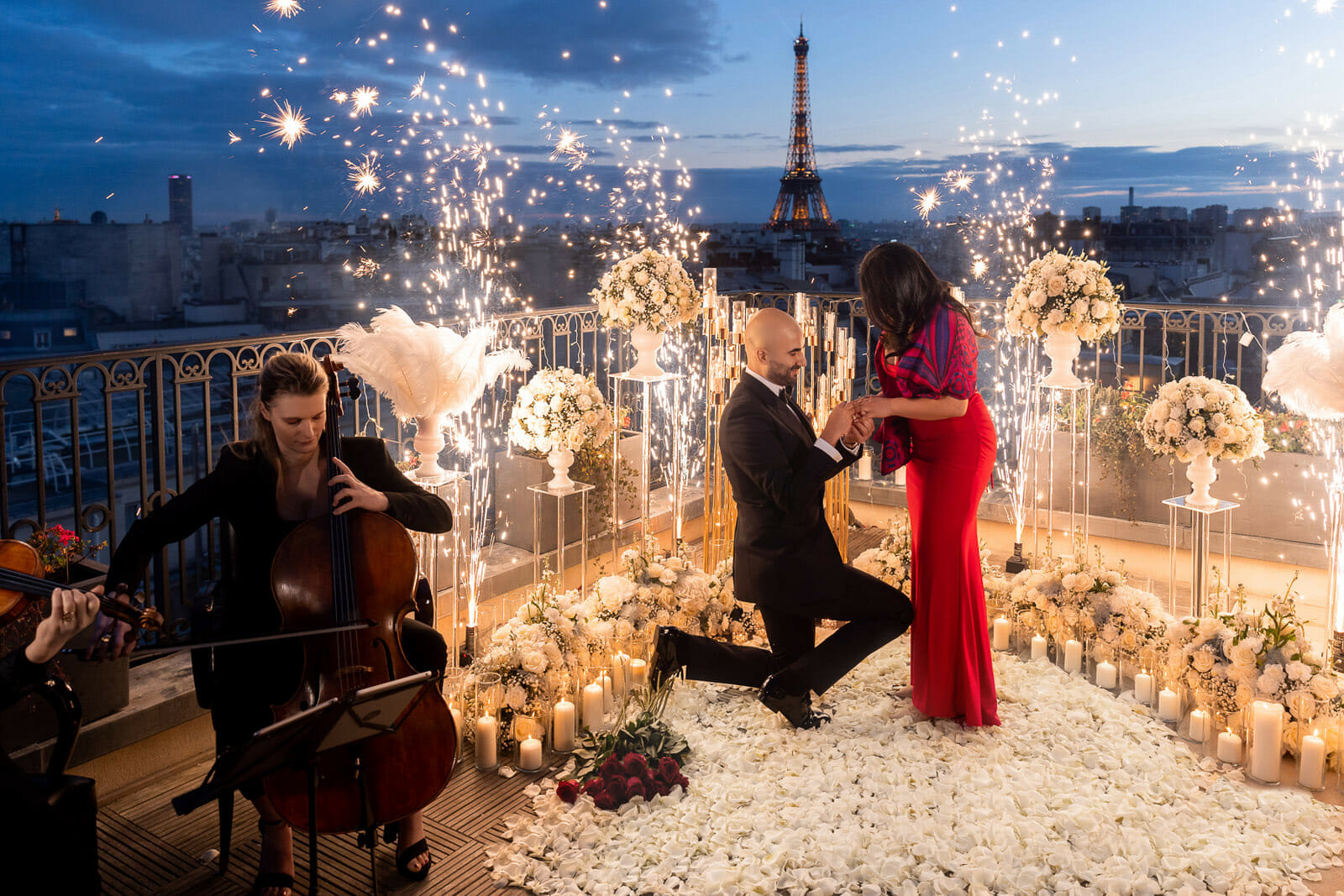 Epic Eiffel Tower Proposal with fireworks fountains, candles, white roses, and musicians