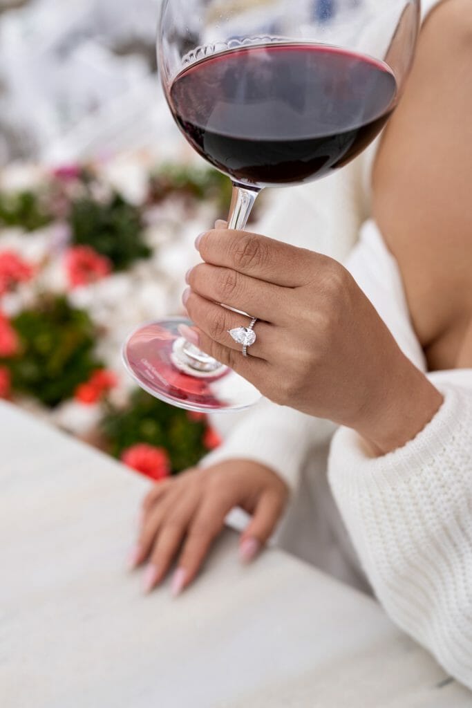 A girl having wine in Santorini Photoshoot