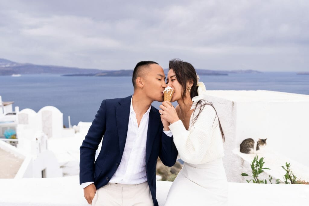 Santorini photoshoot: eating ice cream against a perfect backdrop of the sea.