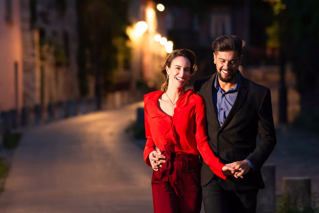 Joyful couple in love during evening Paris engagement photo session near La Maison Rose in Montmartre with romantic sky and cobblestone streets